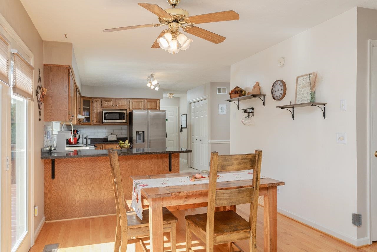 1480 Bluewater Road Harrisonburg, VA 22801 - Photo 11 of 46 a living room with stainless steel appliances furniture a chandelier and a view of kitchen