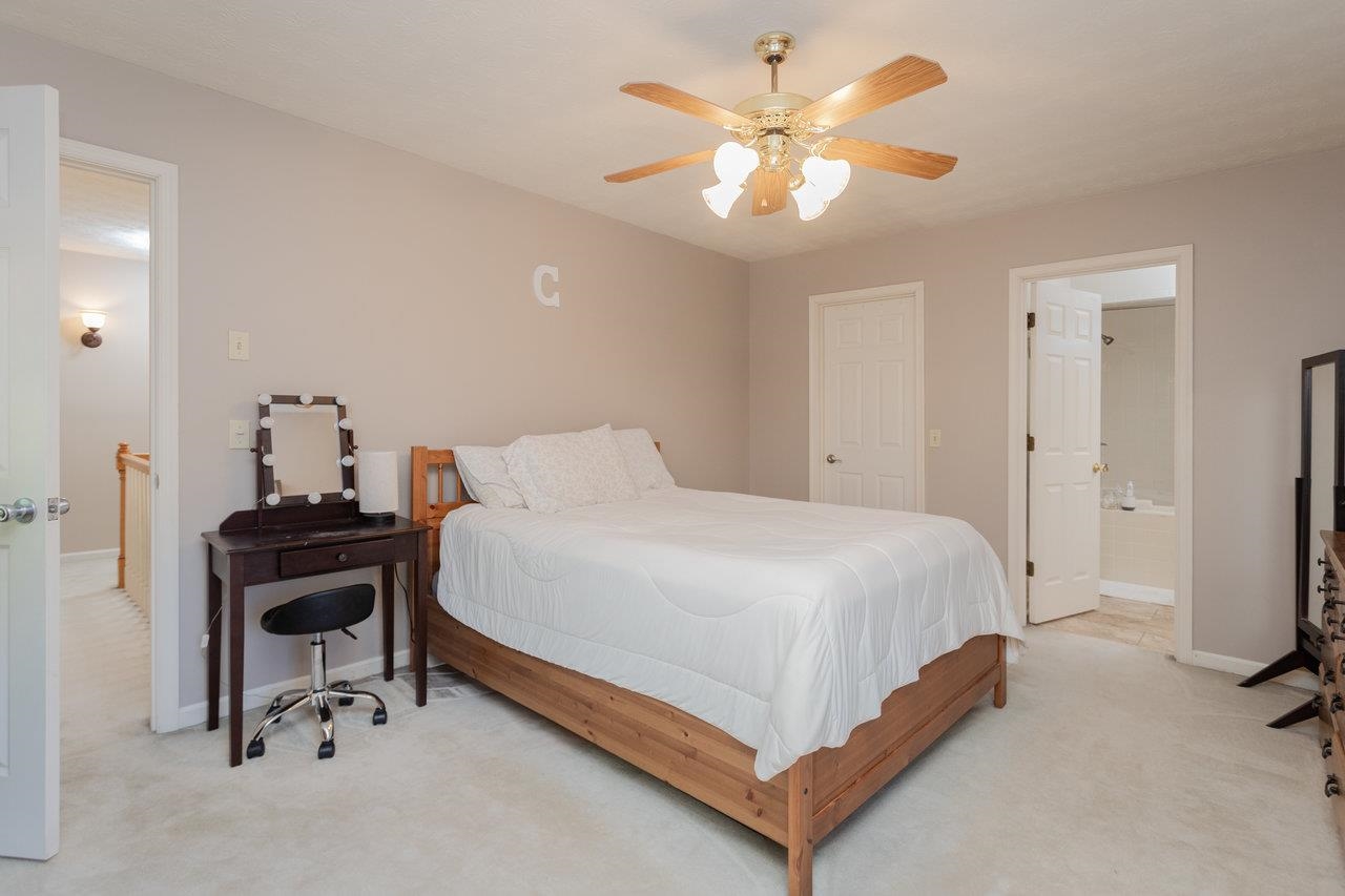 1480 Bluewater Road Harrisonburg, VA 22801 - Photo 21 of 46 a bedroom with a bed and a chandelier