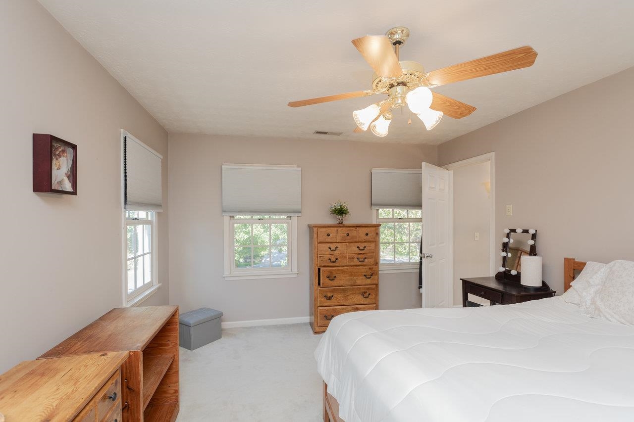 1480 Bluewater Road Harrisonburg, VA 22801 - Photo 22 of 46 a bedroom with a bed and a chandelier