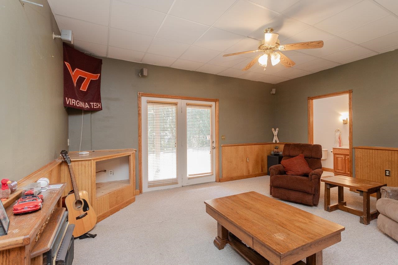 1480 Bluewater Road Harrisonburg, VA 22801 - Photo 31 of 46 a living room with furniture and a chandelier