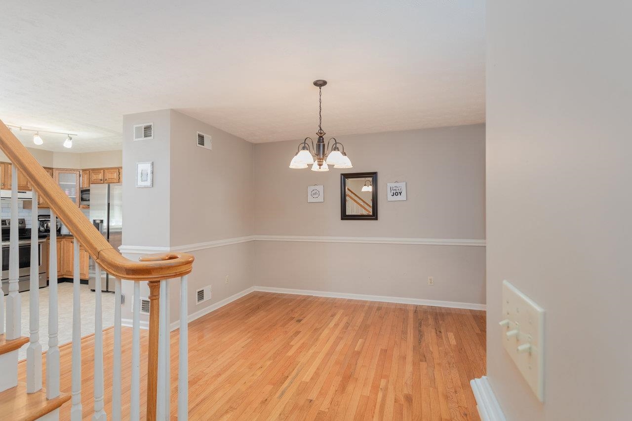 1480 Bluewater Road Harrisonburg, VA 22801 - Photo 5 of 46 a view of a room with wooden floor stairs and a chandelier
