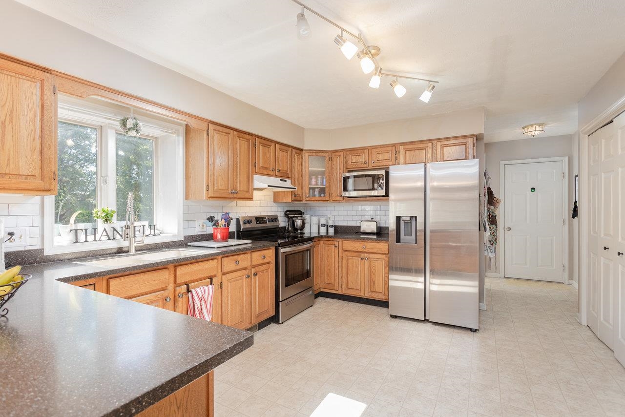 1480 Bluewater Road Harrisonburg, VA 22801 - Photo 7 of 46 a kitchen with stainless steel appliances granite countertop a refrigerator a sink dishwasher a stove and white countertops with wooden floor