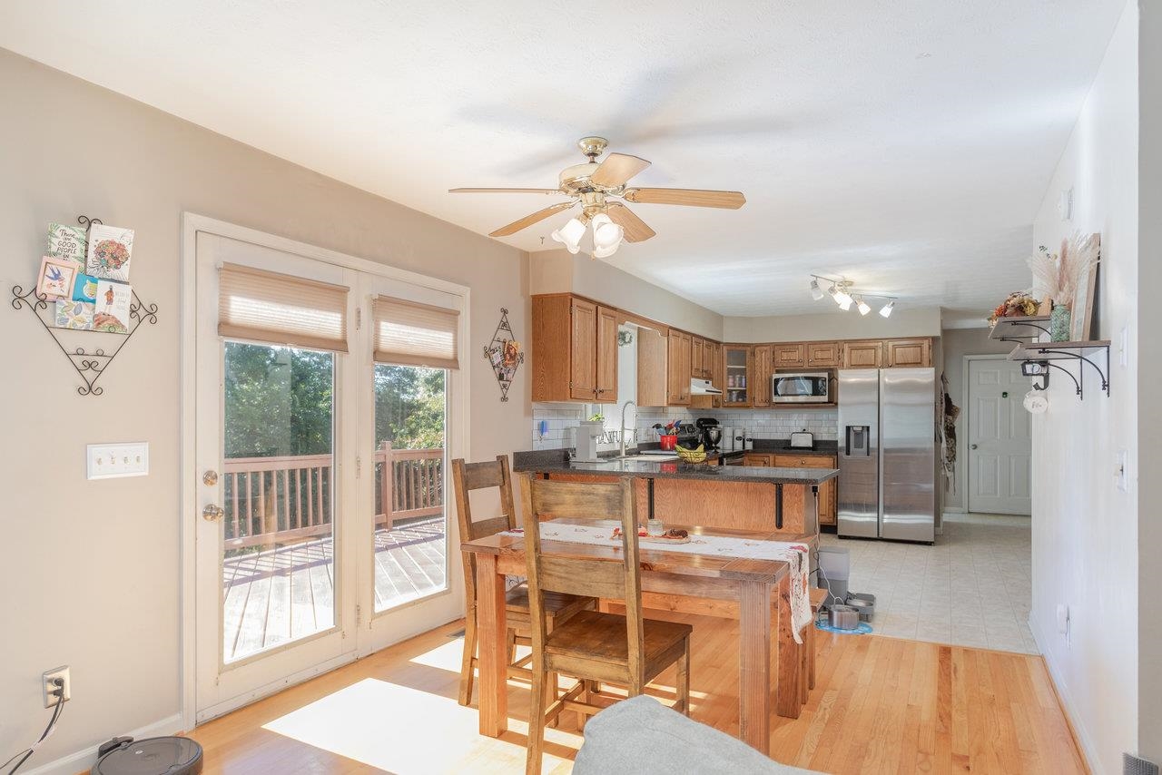1480 Bluewater Road Harrisonburg, VA 22801 - Photo 10 of 46 a view of a dining room with furniture a chandelier and wooden floor