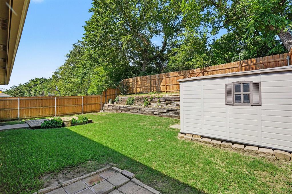 2541 Rivers Edge Drive Fort Worth, TX 76118 - Photo 31 of 31 a view of a backyard with plants and large trees