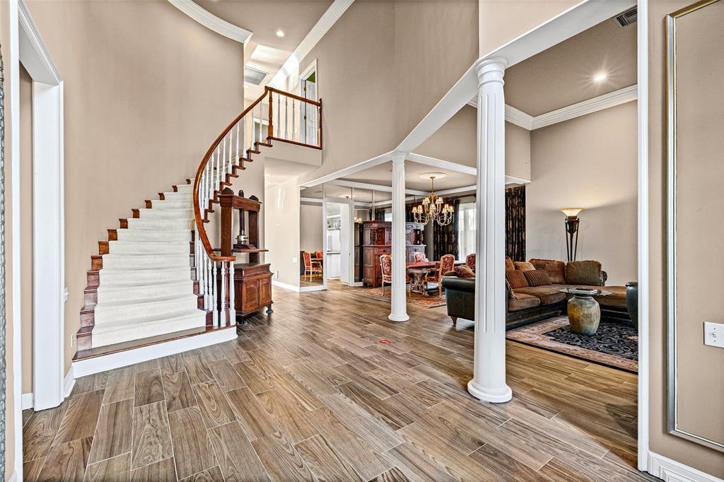 8908 Brierfield Road Granbury, TX 76049 - Photo 4 of 40 a view of a livingroom with wooden floor and furniture