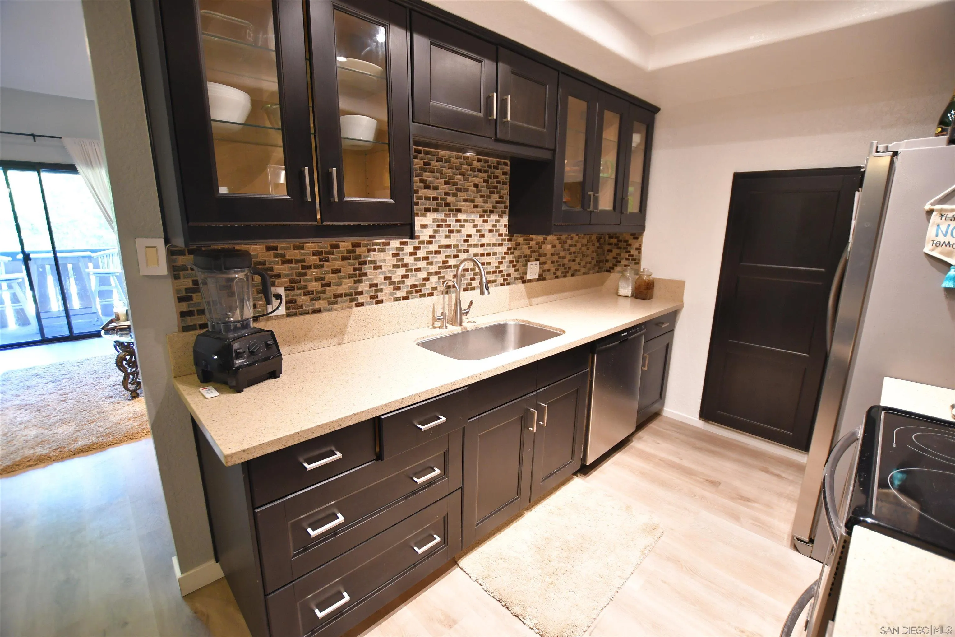 20702 El Toro Road, Unit 258 Lake Forest, CA 92630 - Photo 10 of 30 a kitchen with a sink a refrigerator and cabinets