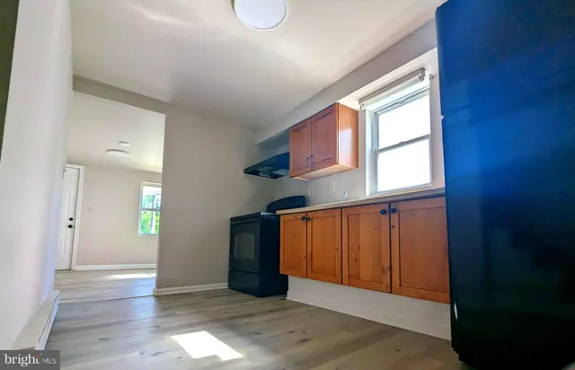 wooden floor in an empty room with windows
