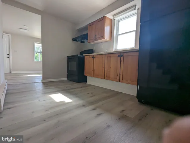 an empty room with windows and closet