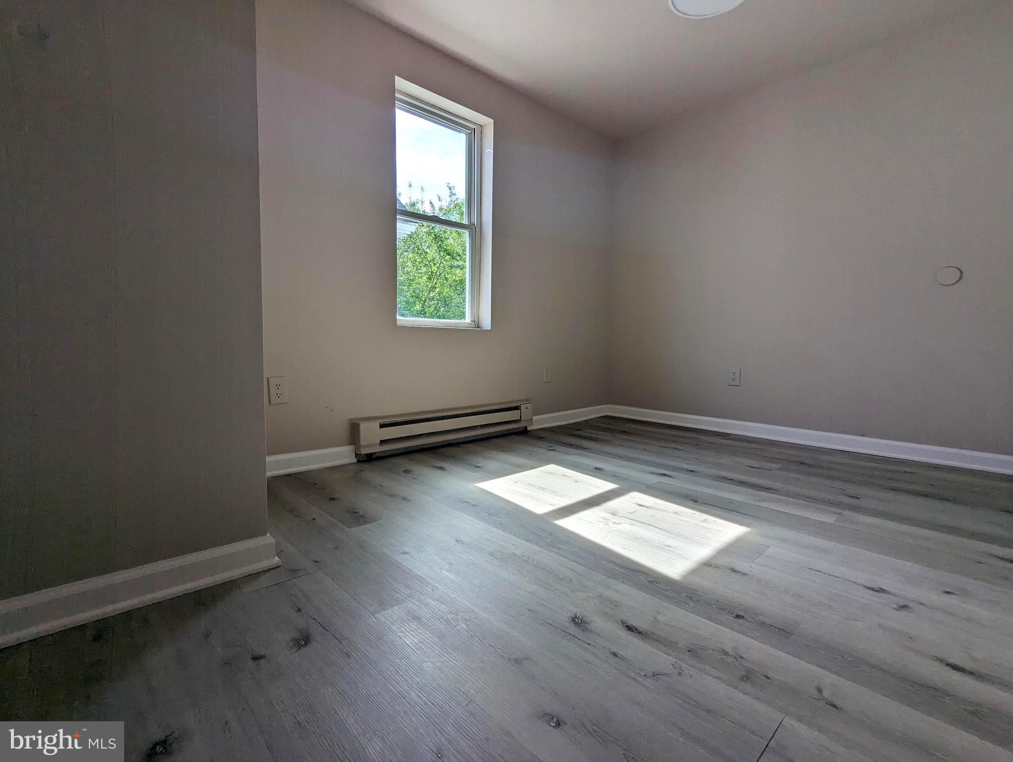810 Washington Street Cambridge, MD 21613 - Photo 8 of 8 an empty room with wooden floor and windows