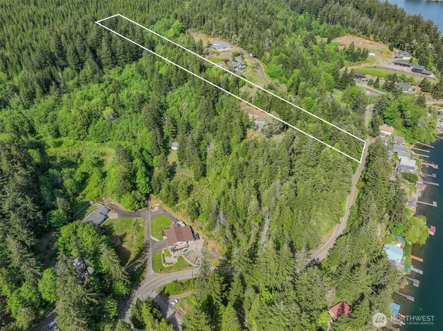a backyard of a house with barbeque oven table and chairs