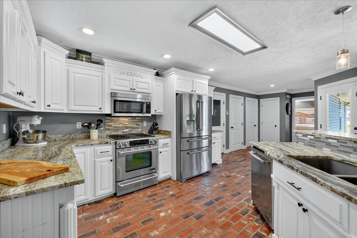 7225 Highway 57 Ramer, TN 38367 - Photo 12 of 68 a kitchen with granite countertop a sink stainless steel appliances and cabinets
