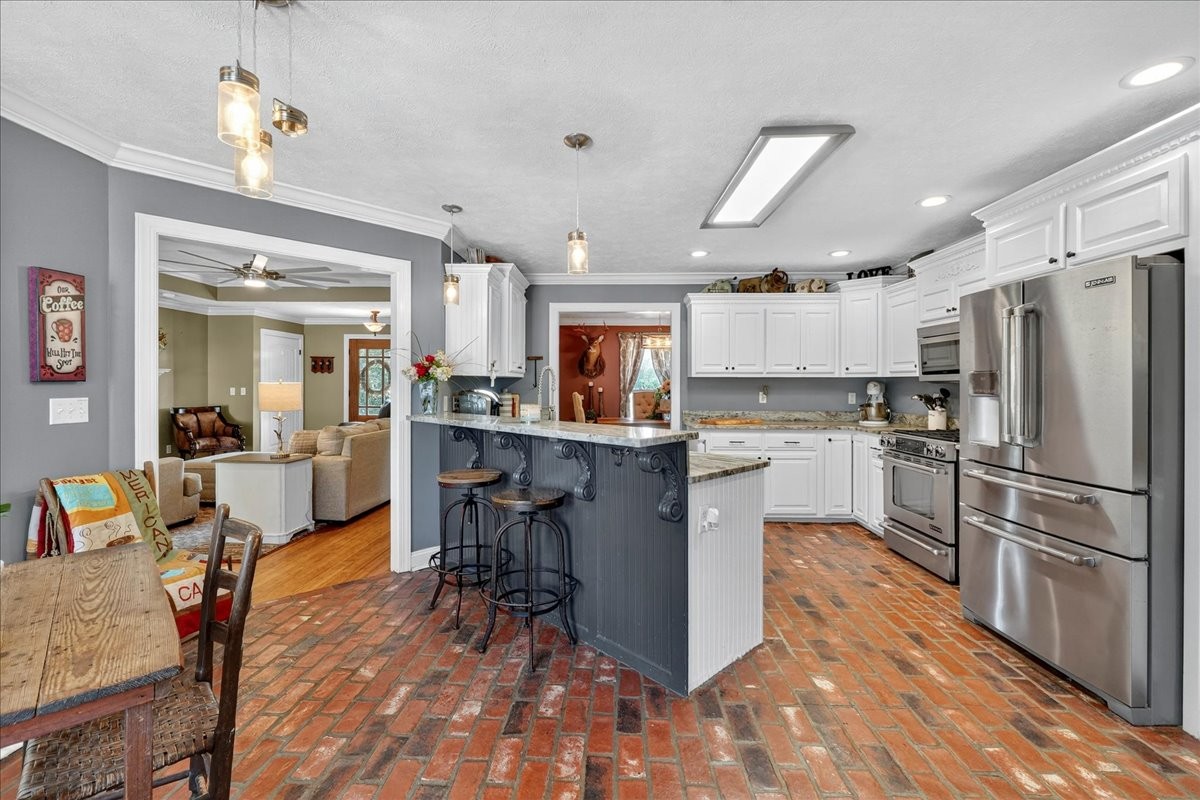 7225 Highway 57 Ramer, TN 38367 - Photo 14 of 68 a kitchen with a refrigerator a counter top space and appliances