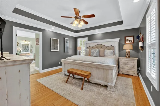 a living room with furniture a flat screen tv and a window