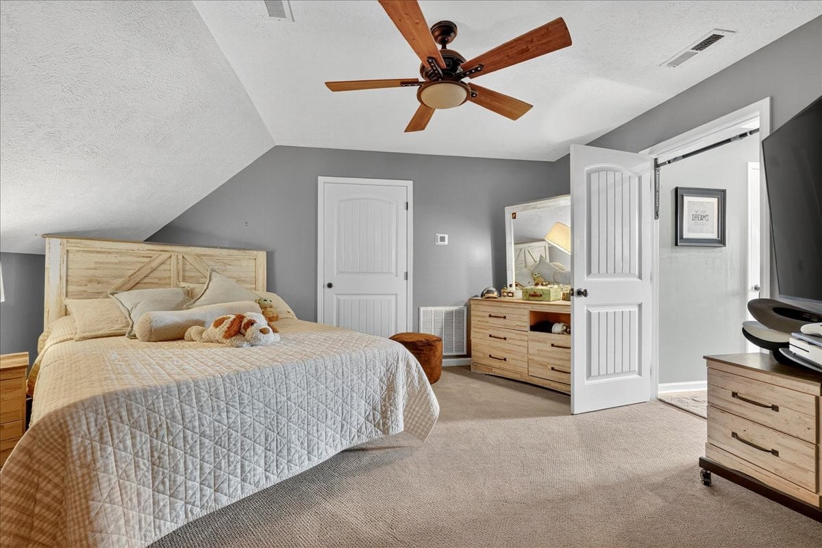 7225 Highway 57 Ramer, TN 38367 - Photo 31 of 68 a bedroom with a bed and a chandelier