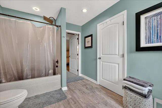 a view of a patio with couches chairs and a table and chairs with wooden floor
