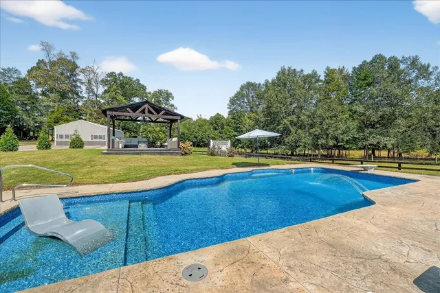 a view of a swimming pool with a yard