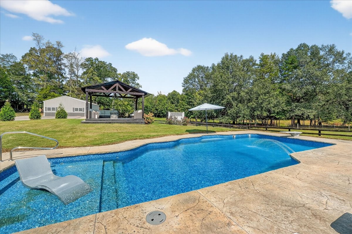 7225 Highway 57 Ramer, TN 38367 - Photo 39 of 68 a view of a swimming pool with an outdoor space and seating area