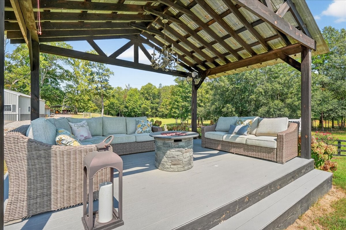 7225 Highway 57 Ramer, TN 38367 - Photo 41 of 68 a view of a patio with couches chairs and a table and chairs with wooden floor
