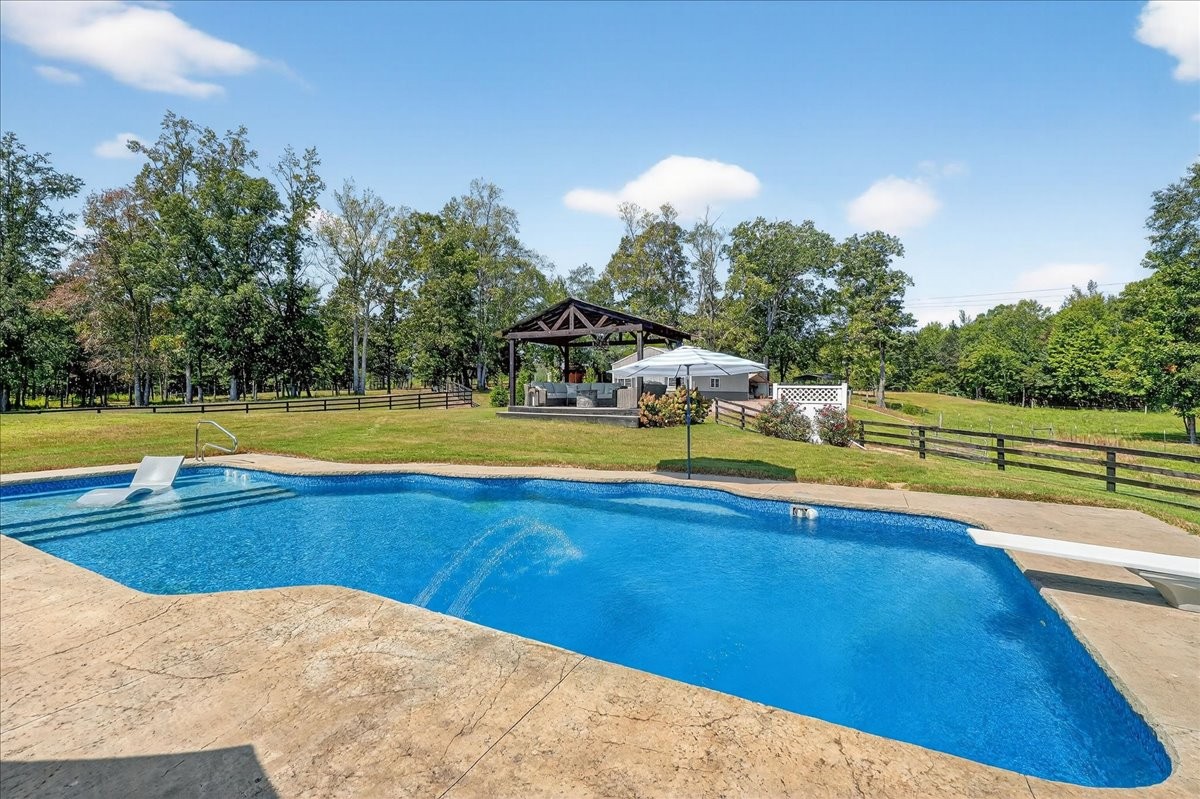 7225 Highway 57 Ramer, TN 38367 - Photo 45 of 68 a view of a swimming pool with an outdoor space and seating area