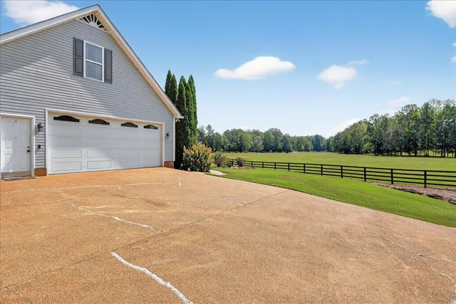 an aerial view of lake residential house with outdoor space and trees around