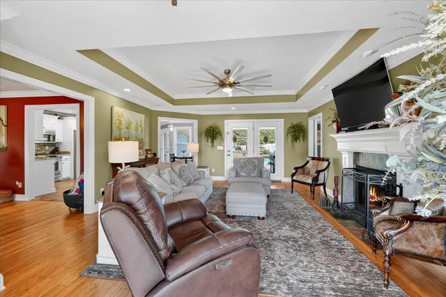 a living room with furniture a fireplace and a flat screen tv