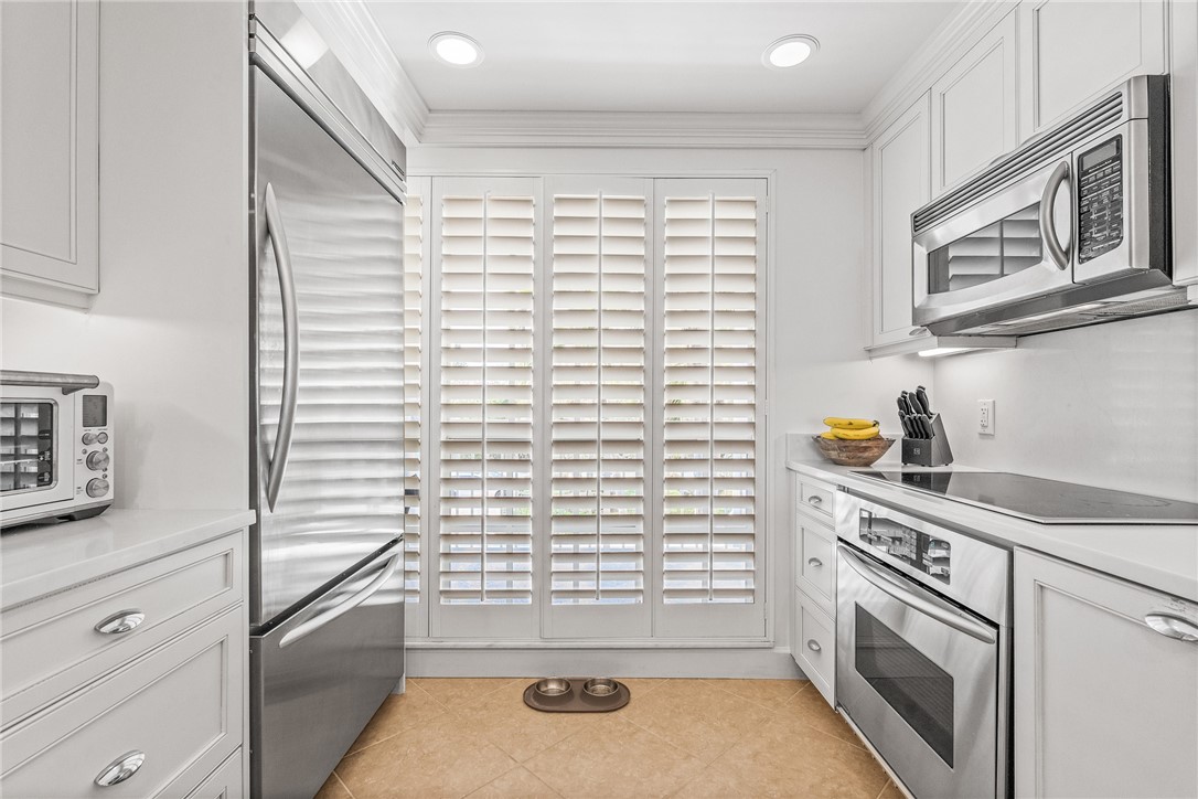 550 Beach Road, Unit 223 Vero Beach, FL 32963 - Photo 15 of 36 a kitchen with a stove and a white cabinet