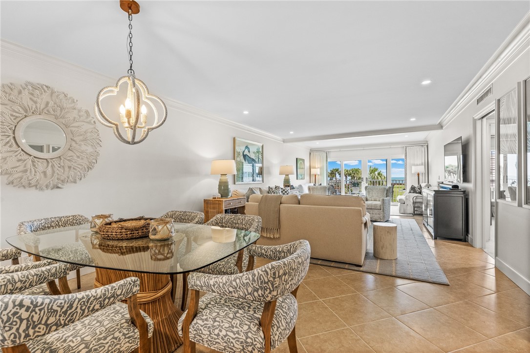550 Beach Road, Unit 223 Vero Beach, FL 32963 - Photo 19 of 36 a dining room filled with furniture a chandelier and wooden floor