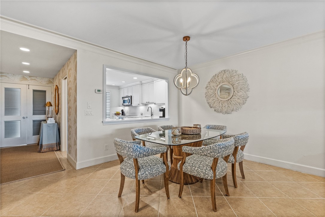 550 Beach Road, Unit 223 Vero Beach, FL 32963 - Photo 21 of 36 a view of a dining room and chandelier
