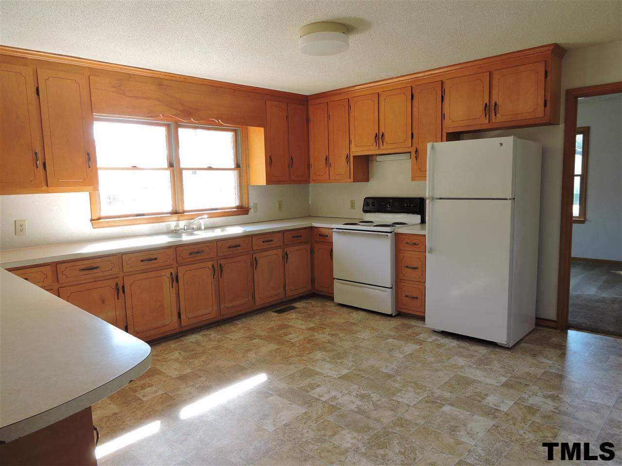 5119 Green Riley Road Rougemont, NC 27572 - Photo 2 of 25 a kitchen with stainless steel appliances granite countertop a refrigerator sink and cabinets