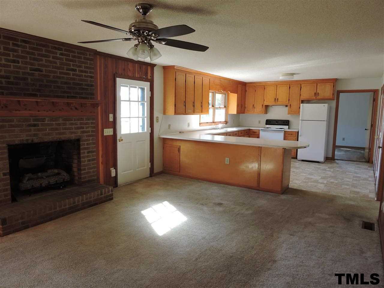 5119 Green Riley Road Rougemont, NC 27572 - Photo 4 of 25 a open kitchen with furniture a fireplace and a window