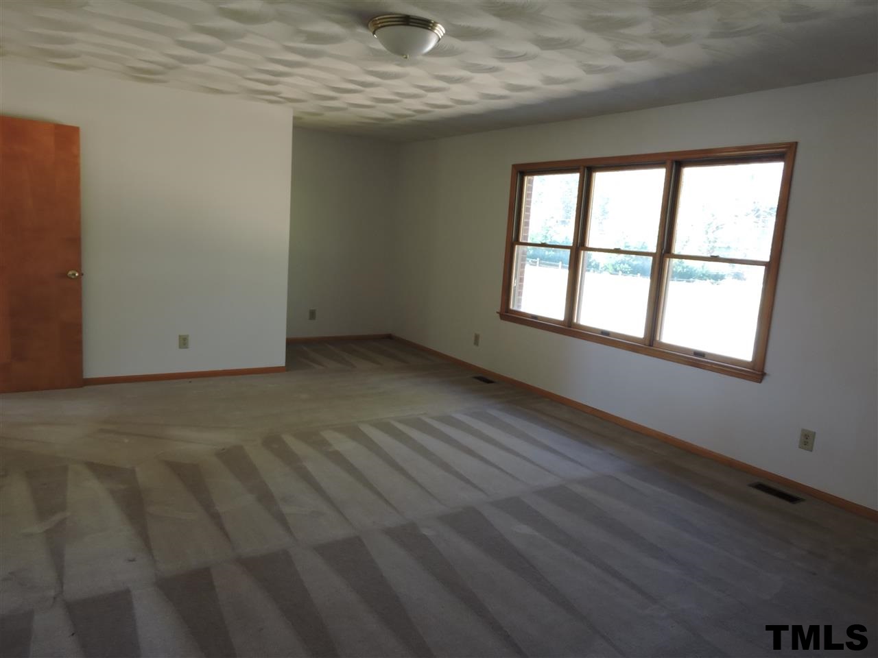 5119 Green Riley Road Rougemont, NC 27572 - Photo 8 of 25 an empty room with wooden floor and windows