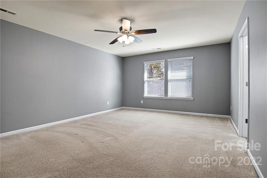 6170 Durango Way Denver, NC 28037 - Photo 31 of 38 an empty room with windows and chandelier fan