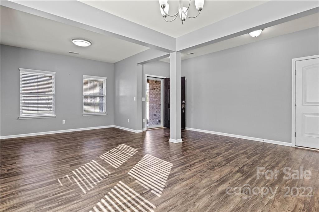 6170 Durango Way Denver, NC 28037 - Photo 5 of 38 a view of an empty room with wooden floor and a window