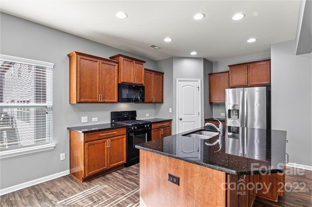 6170 Durango Way Denver, NC 28037 - Photo 10 of 38 a kitchen with stainless steel appliances granite countertop a sink stove and refrigerator