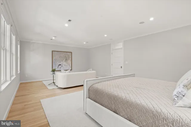 a spacious bedroom with a bed and a window