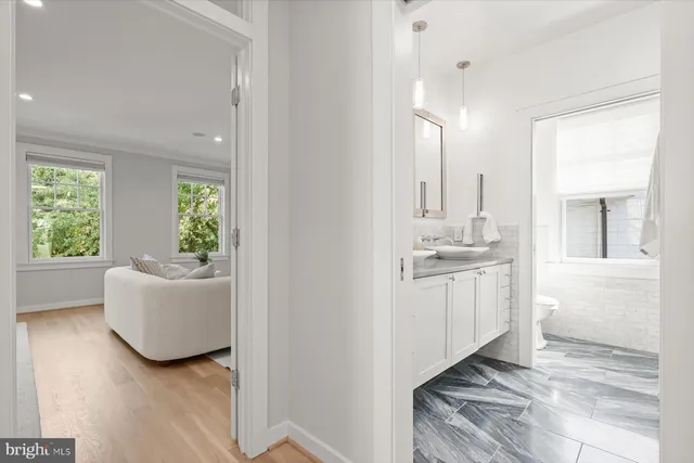 a bathroom with a sink mirror and a bathtub