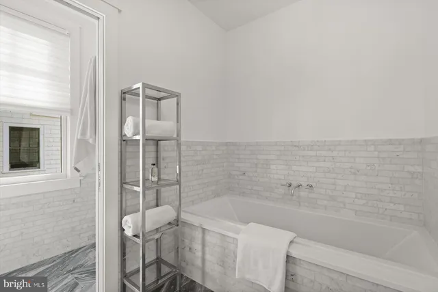 a bathroom with a bathtub and shower