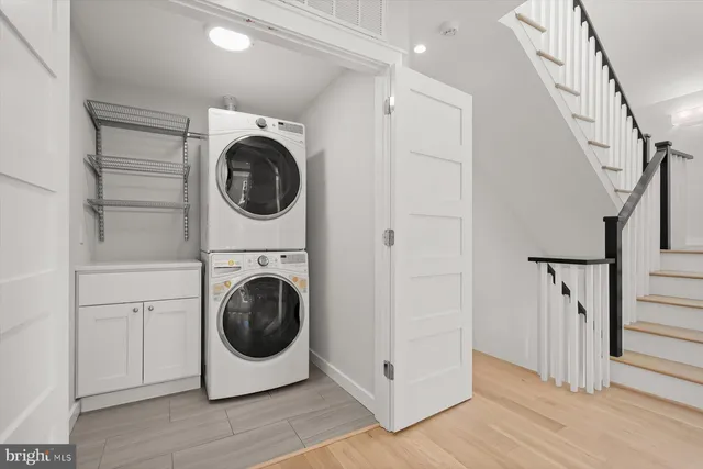 a utility room with sink dryer and washer