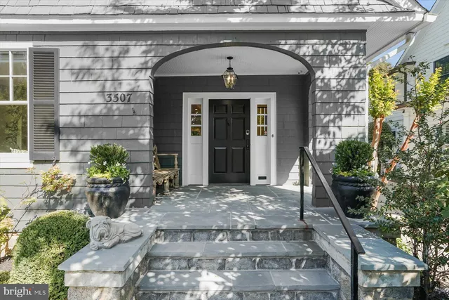 a front view of a house with potted plants