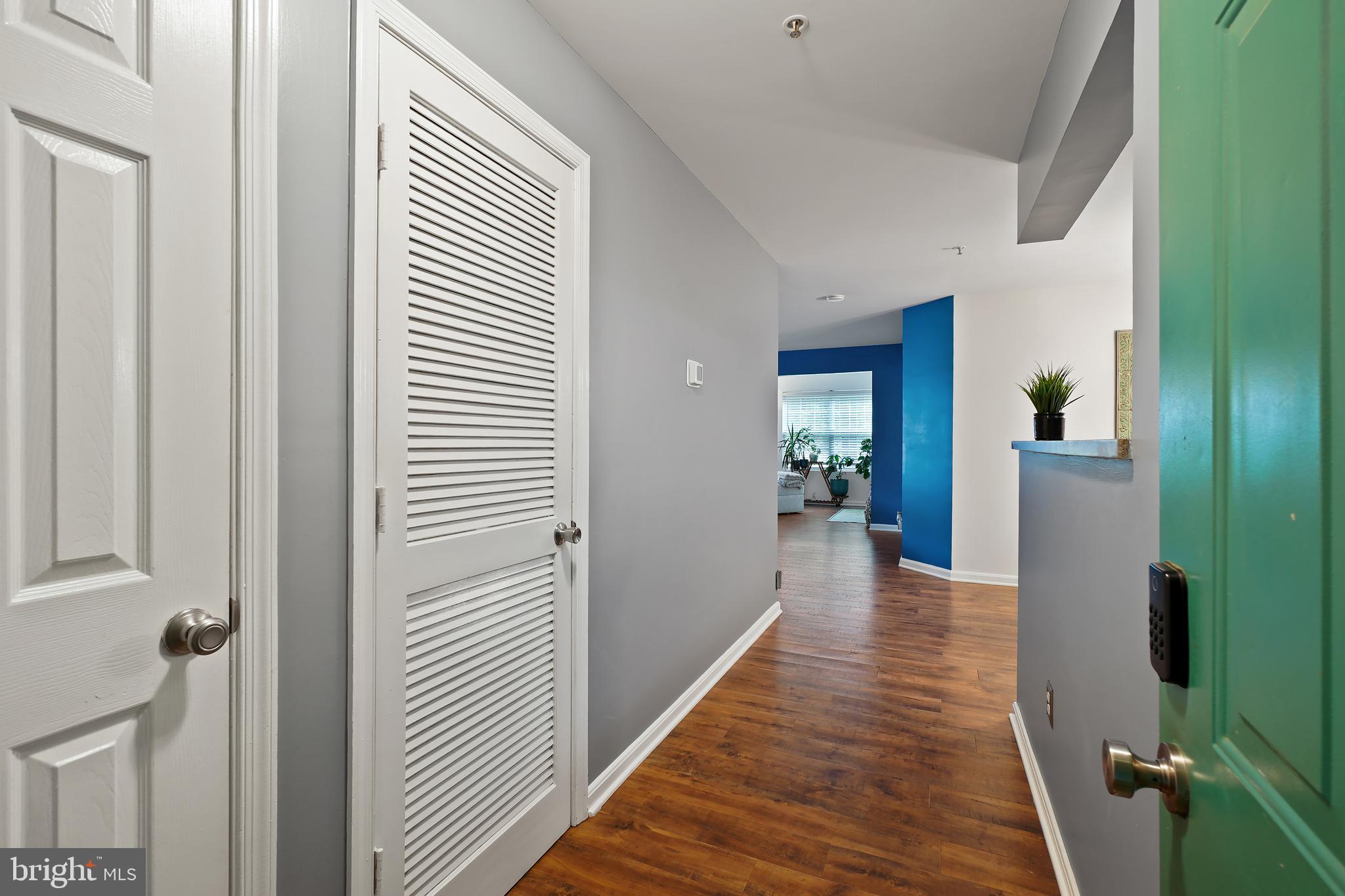 14151 Cuddy Loop, Unit 101 Woodbridge, VA 22193 - Photo 3 of 45 a view of a hallway with wooden floor and a bathroom