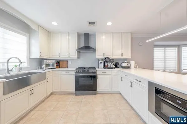 a kitchen with a sink stove and cabinets