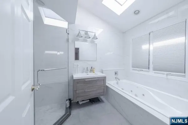 a bathroom with a bathtub shower and a sink