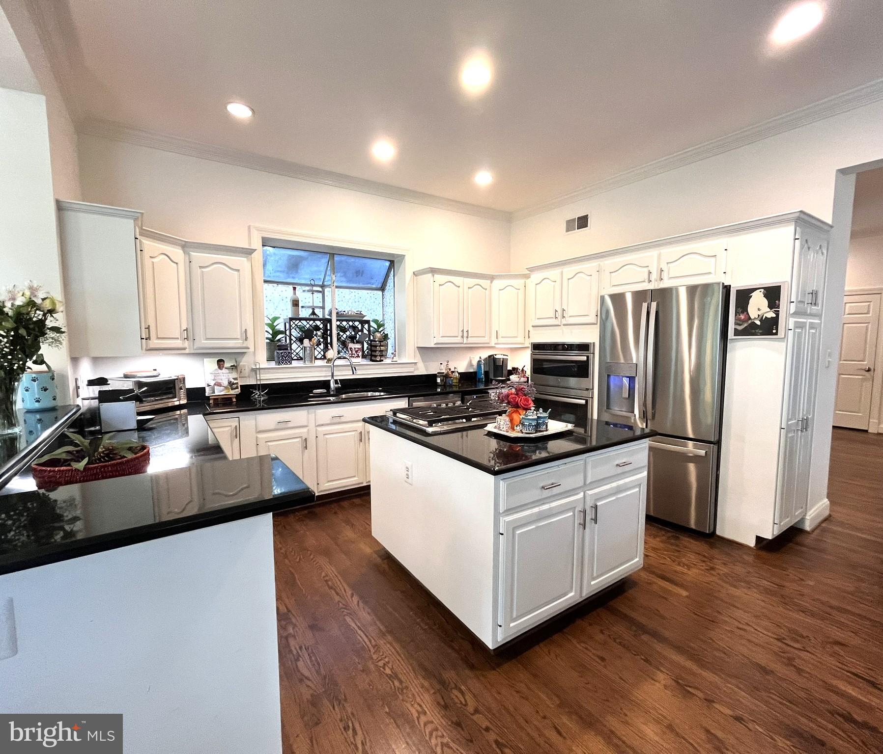 7809 Fox Gate Court Bethesda, MD 20817 - Photo 2 of 42 a kitchen with stainless steel appliances a sink a stove a refrigerator and island