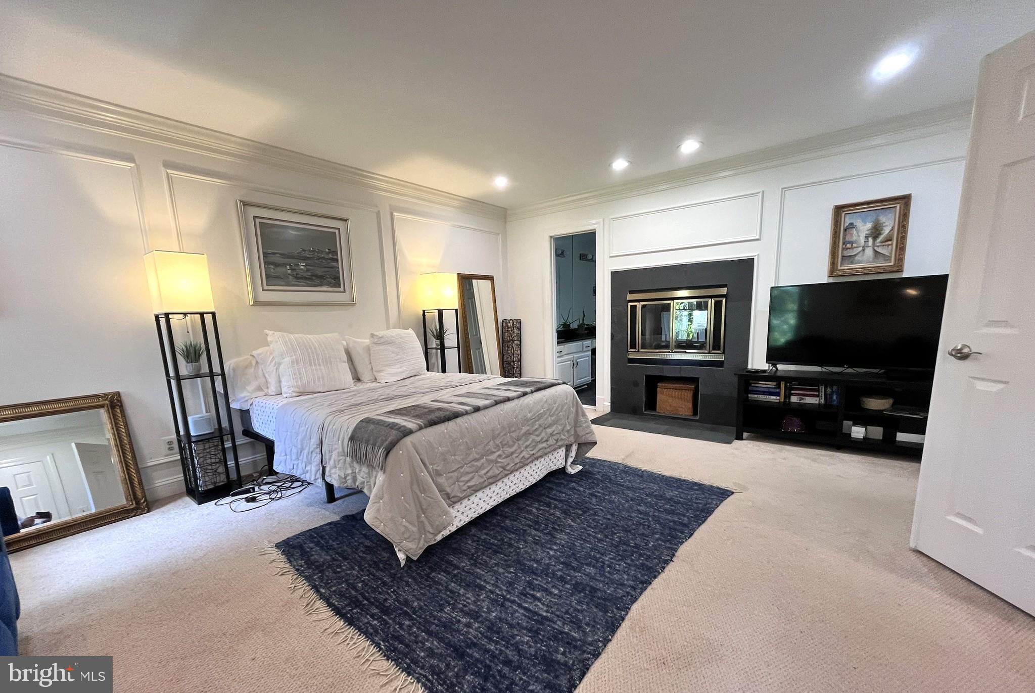 7809 Fox Gate Court Bethesda, MD 20817 - Photo 23 of 42 a spacious bedroom with a bed and a flat screen television