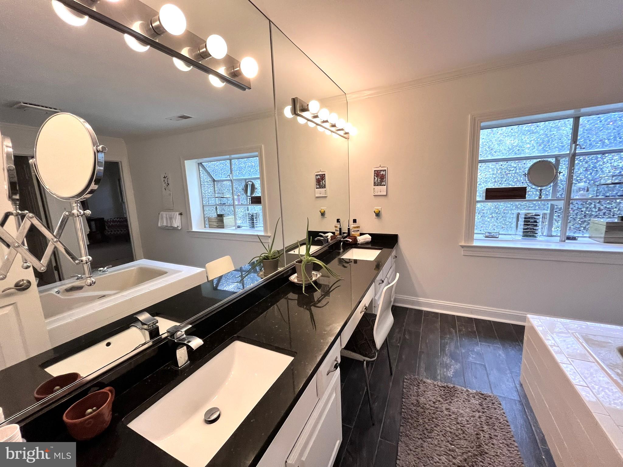7809 Fox Gate Court Bethesda, MD 20817 - Photo 25 of 42 a room with a large mirror and a sink