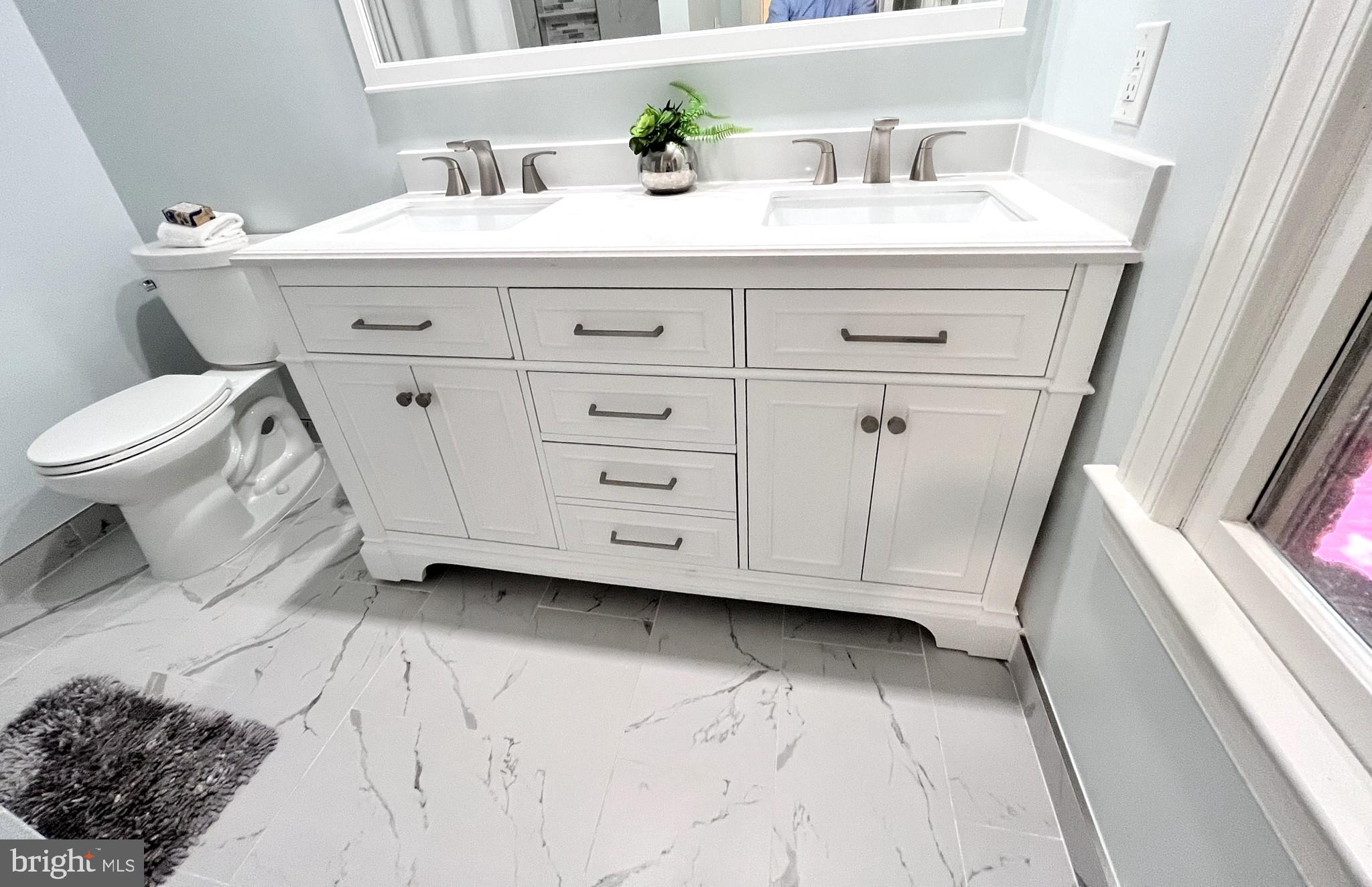 7809 Fox Gate Court Bethesda, MD 20817 - Photo 27 of 42 a bathroom with a sink a toilet and a mirror