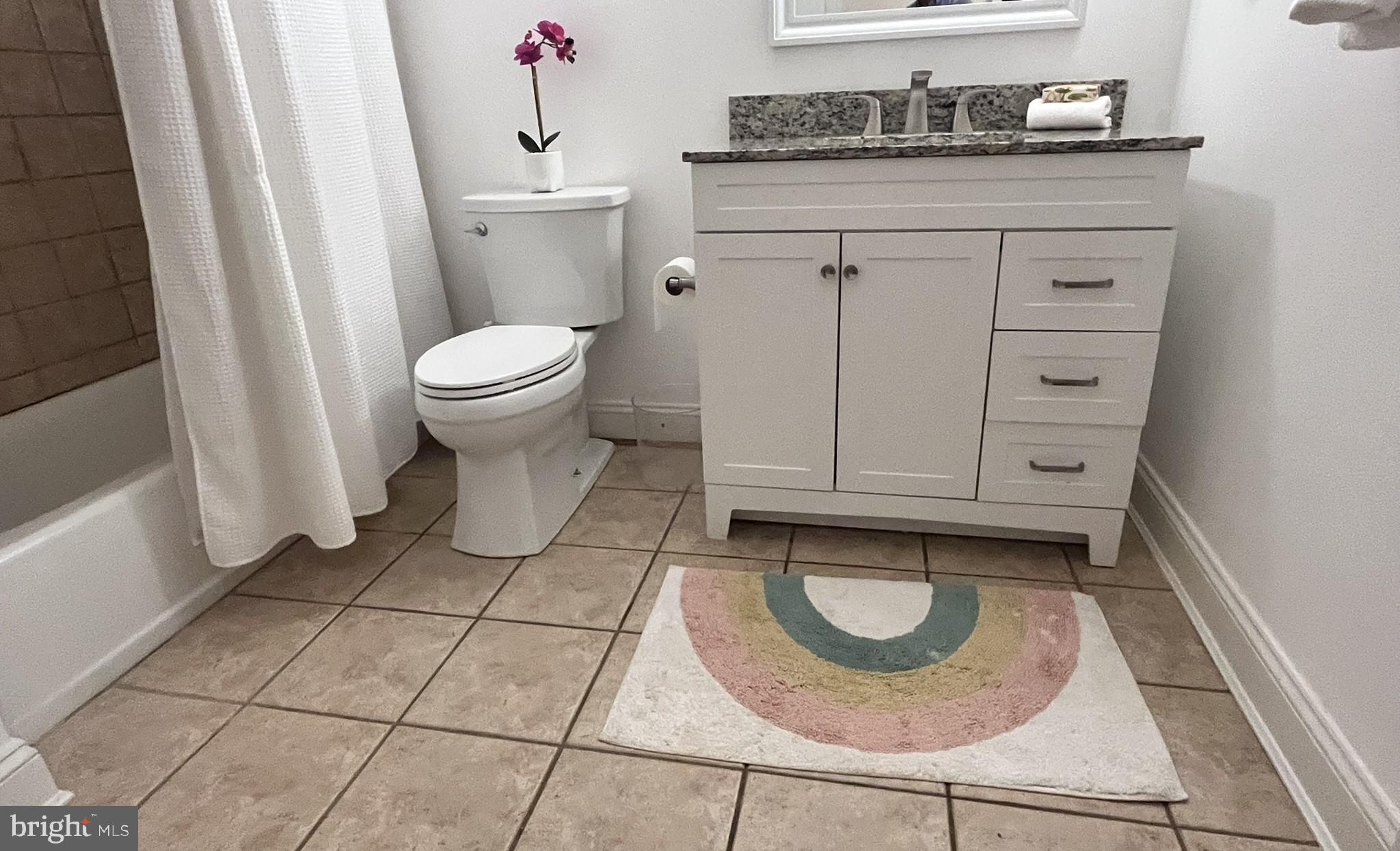 7809 Fox Gate Court Bethesda, MD 20817 - Photo 32 of 42 a bathroom with a granite countertop sink a toilet and a mirror