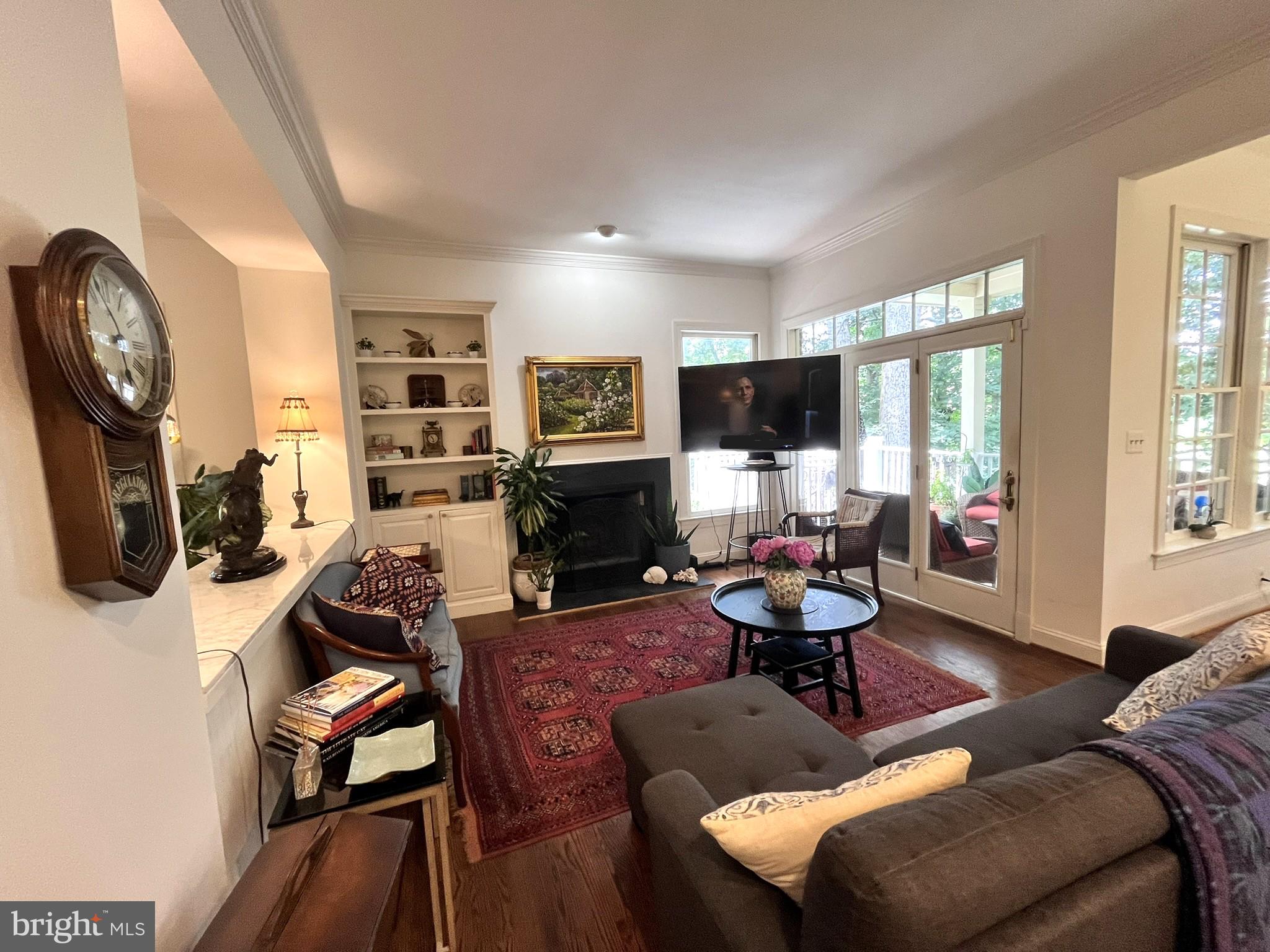 7809 Fox Gate Court Bethesda, MD 20817 - Photo 8 of 42 a living room with furniture a window and a fireplace