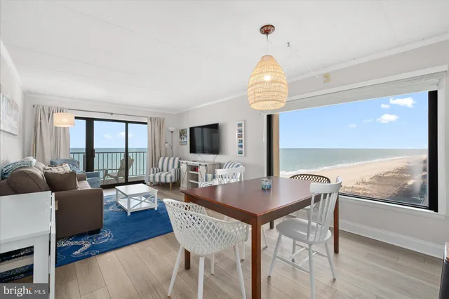 a view of a dining room with furniture wooden floor and chandelier