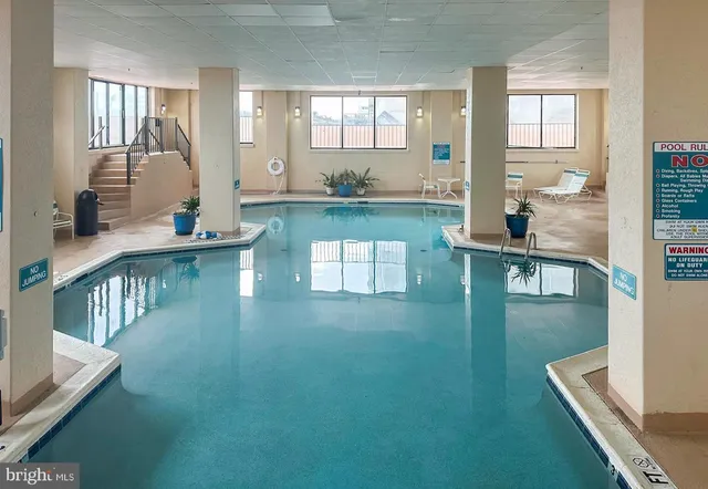 a view of kitchen with counter top space and living room